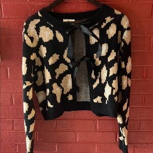 Stylish Black and Cream Sweater with Bow Accents